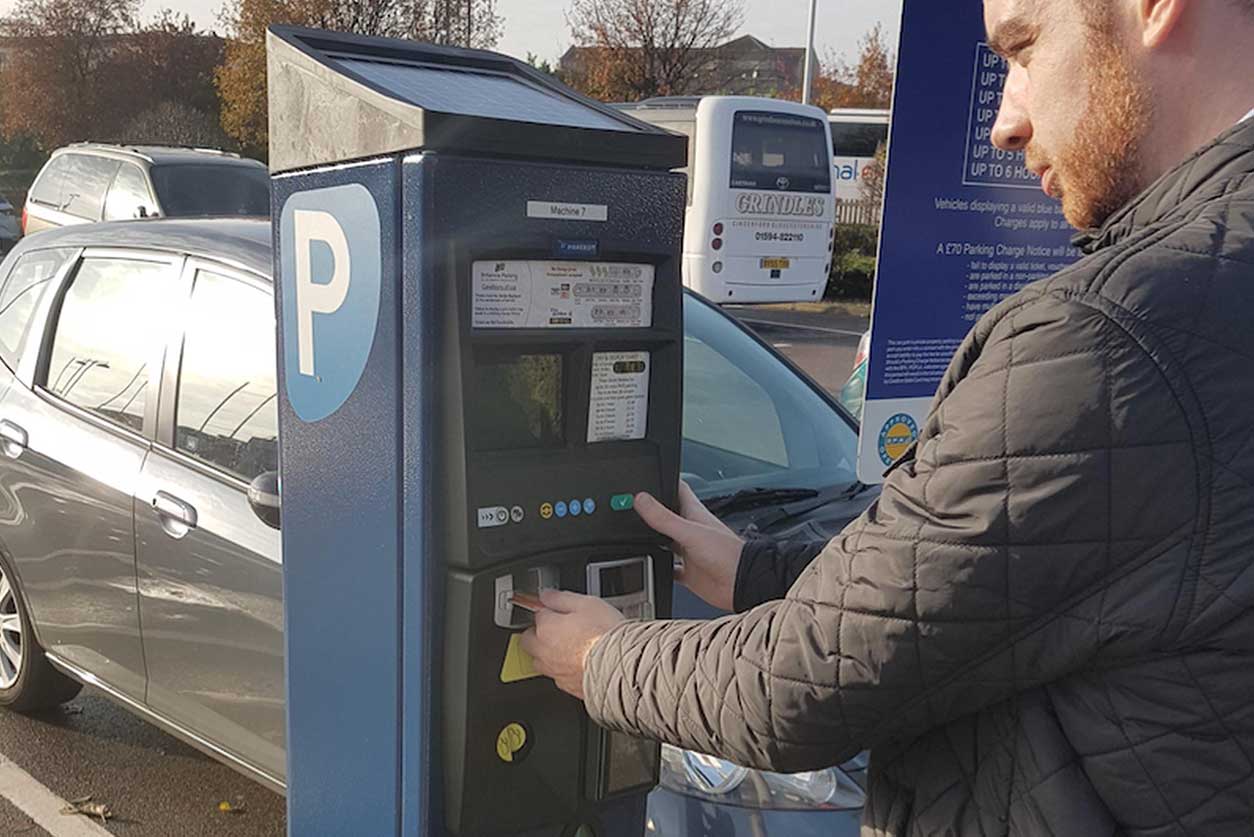 Man at pay and display machine
