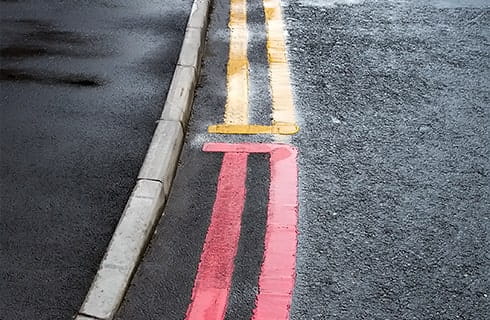 yellow and red double lines on a road