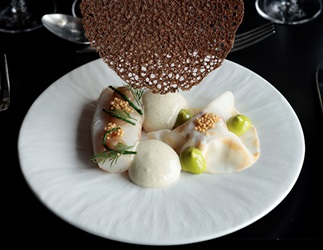 Gourmet fish dish with herbs and crispy garnish – artistic plating with sauce and fine dining presentation - Parking Det Glade Vanvid