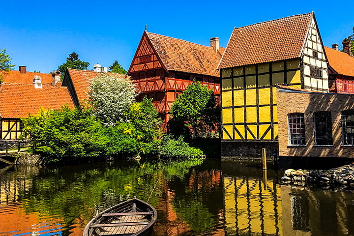 Aarhus Old town with a little lake with a boat on and old houses by the water edge