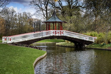 Frederiksberg Have walkway over the small pond with a wooden pergola on top. 