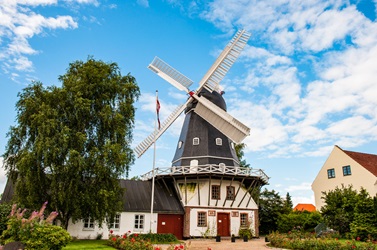Ringsted old mill with blue skies and greenery around